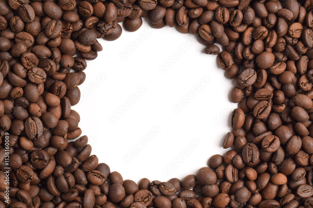 Roasted coffee beans with a circle Frame in the center on a white background. Top view with copy space for your text Roasted coffee beans with a circle Frame in the center on a white background. Top view with copy space for your text