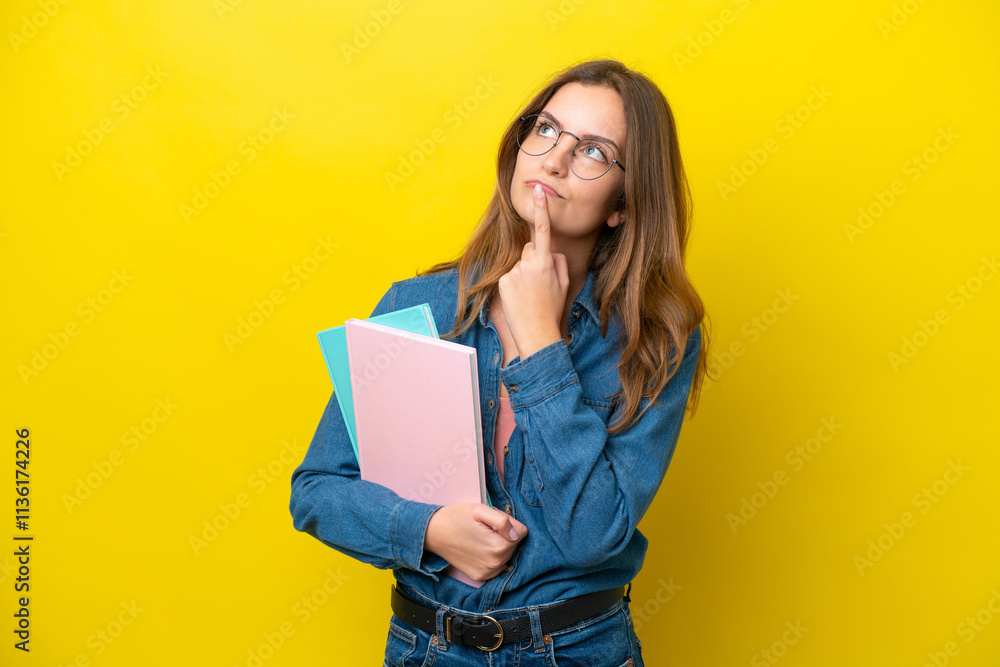 Young student caucasian woman isolated on yellow background having doubts while looking up Young student caucasian woman isolated on yellow background having doubts while looking up