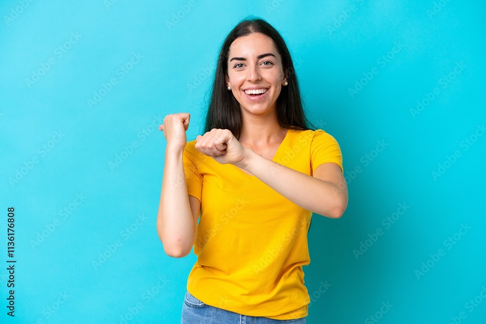 Fototapeta premium Young caucasian woman isolated on blue background pointing to the side to present a product