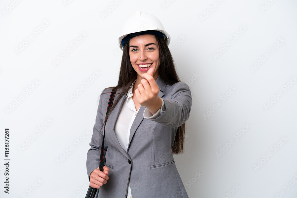 Young architect caucasian woman with helmet and holding blueprints isolated on white background making money gesture Young architect caucasian woman with helmet and holding blueprints isolated on white background making money gesture