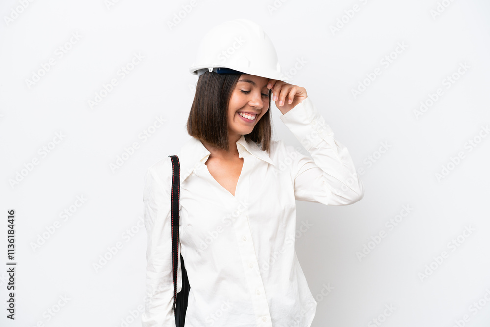 Young architect woman with helmet and holding blueprints isolated on white background laughing Young architect woman with helmet and holding blueprints isolated on white background laughing