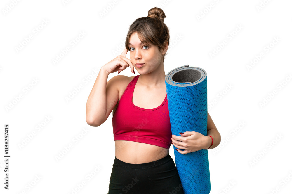 Young sport girl going to yoga classes while holding a mat over isolated chroma key background thinking an idea Young sport girl going to yoga classes while holding a mat over isolated chroma key background thinking an idea