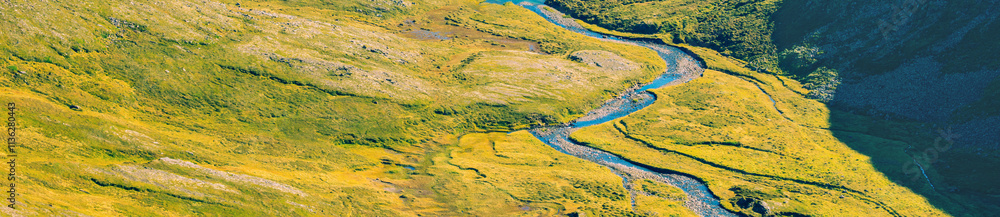 Beautiful nature background. Panorama landscape. Texture of earth. Winding mountain river. Aerial view. Horizontal banner