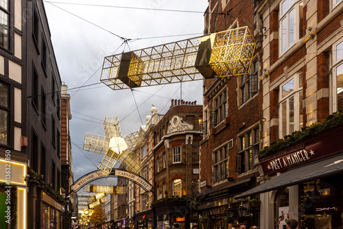 London, UK – December 1, 2024. A light installation on Carnaby Street for Christmas during a gloomy, rainy twilight. photo