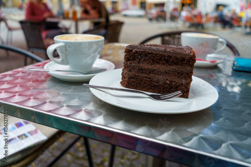 Slice of Chocolate Cake and Coffee on Cafe Table