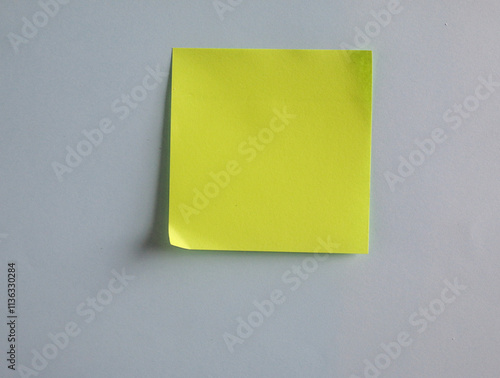 Blank light green post-it note on a grey background. Customize the dark tone.