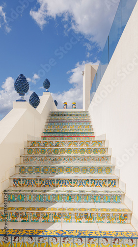 Traditional Sicilian Staircase with Colorful Patterns and Ceramic Tiles. A beautifully decorated staircase in Sicily, featuring vibrant traditional patterns and ceramic tiles.