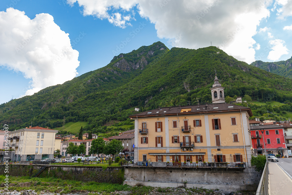 SAN PELLEGRINO TERME, ITALY - MAY 12, 2024: Historical buildings of San Pellegrino Terme and green mountains at the background SAN PELLEGRINO TERME, ITALY - MAY 12, 2024: Historical buildings of San Pellegrino Terme and green mountains at the background