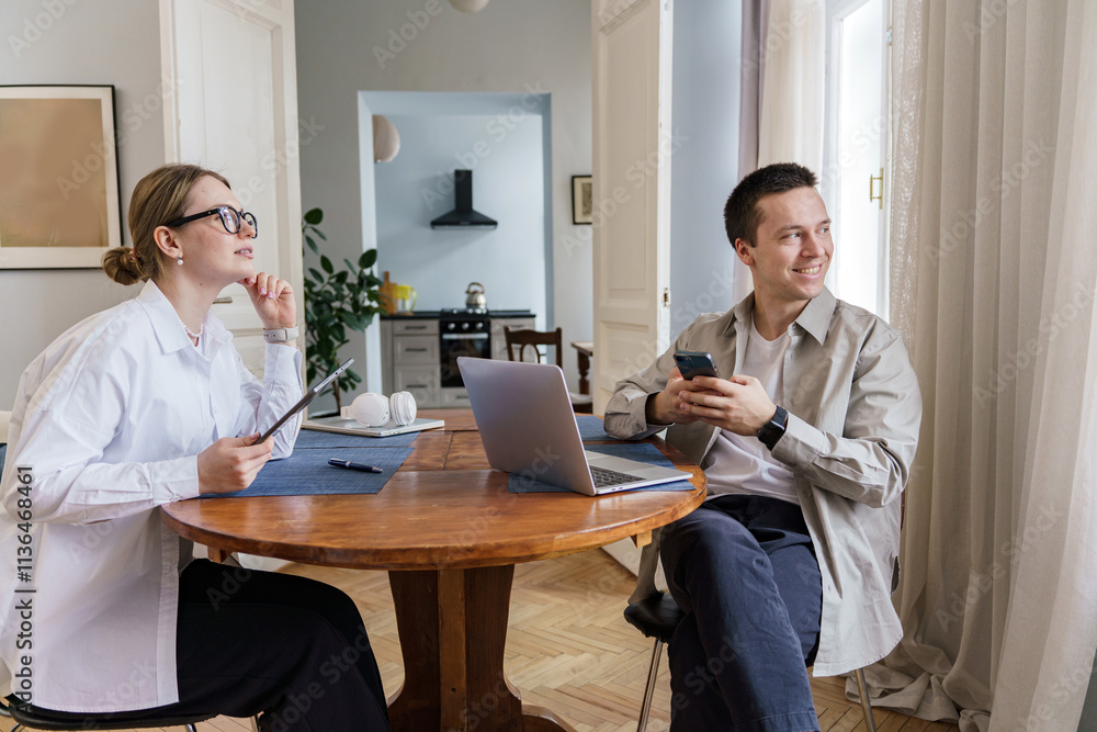 Collaborative discussion in a cozy home office setting during a productive work session Collaborative discussion in a cozy home office setting during a productive work session
