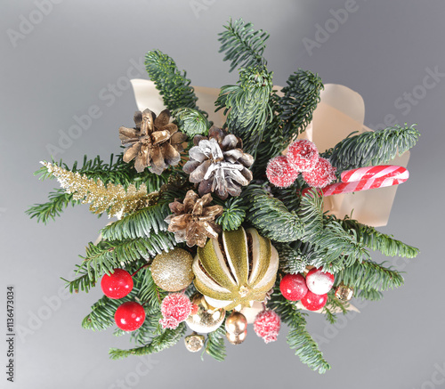 A traditional Christmas floral arrangement of green fir branches and flowers. New Year's decor for the interior