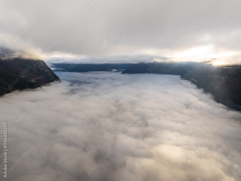 Obraz premium clouds in the mountains, over the fjord.