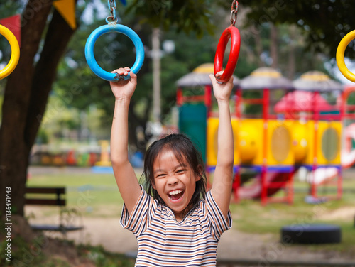 Photography Happy girl hanging on monkey bar by hand doing exercise