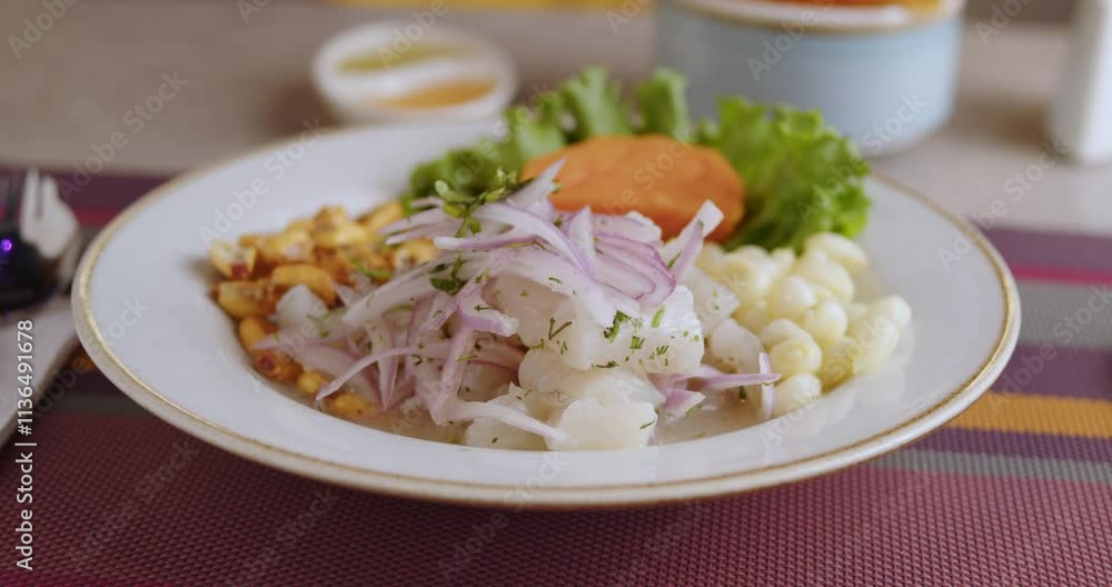 Closeup slow-motion display of delicious Peruvian Ceviche served in white plate Closeup slow-motion display of delicious Peruvian Ceviche served in white plate