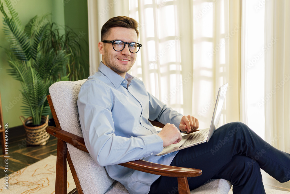 Man working on laptop in a cozy indoor setting with natural light during the day Man working on laptop in a cozy indoor setting with natural light during the day