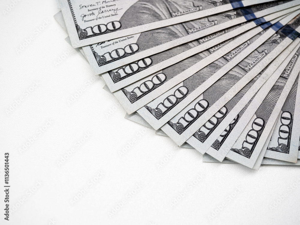 Close-up of 100 us Dollars, money banknotes, arranged as a fan, money cash isolated on white background with copy space. One hundred numbers on many dollar bill banknote, top view. Close-up of 100 us Dollars, money banknotes, arranged as a fan, money cash isolated on white background with copy space. One hundred numbers on many dollar bill banknote, top view.