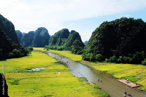 Take a boat trip in Tam Coc with majestic rice fields and mountains on both sides