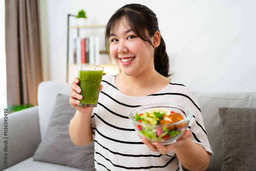 Beautiful Asian woman holding a bowl of salad and green vegetable and fruit juice. Healthy food Beautiful Asian woman holding a bowl of salad and green vegetable and fruit juice. Healthy food