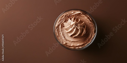 Chocolate cream in a glass on a brown background. Copy space. photo