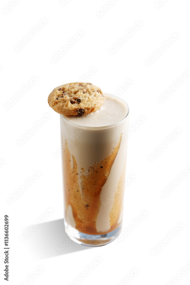 A glass of milkshake with a cookie on top of it A glass of milkshake with a cookie on top of it