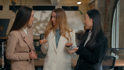 Happy smiling laughing joyful positive friendly business women people colleagues females multiracial multiethnic girls businesswomen diversity Caucasian Asian Korean friends talking in office laugh photo