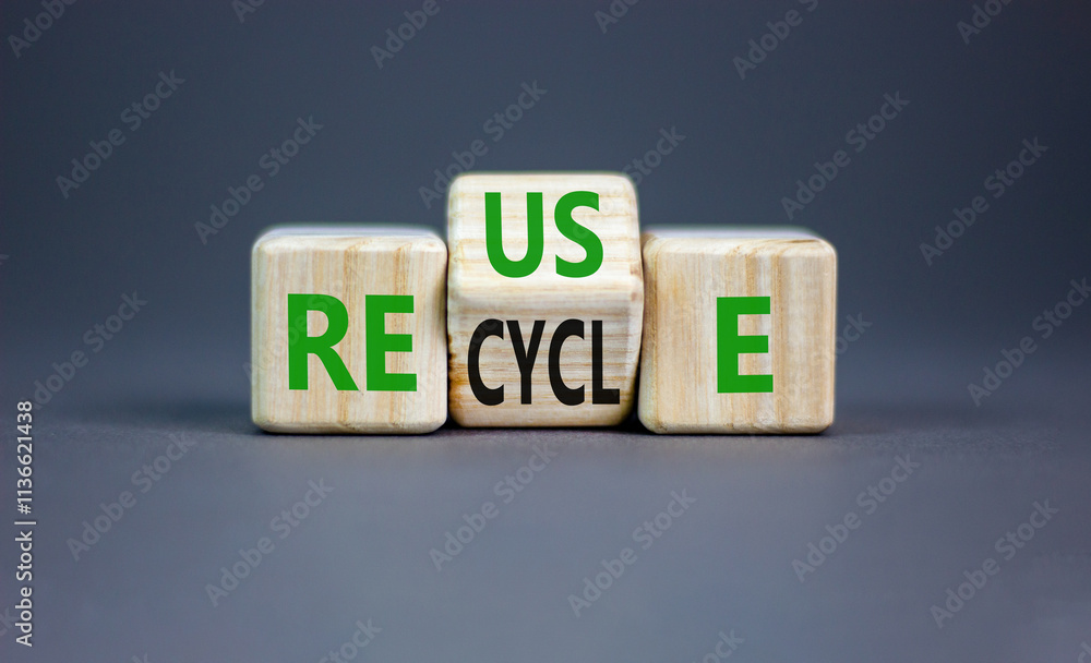 Reuse or recycle symbol. Concept words Reuse Recycle on wooden block. Beautiful grey table grey background. Business reuse or recycle concept. Copy space. Reuse or recycle symbol. Concept words Reuse Recycle on wooden block. Beautiful grey table grey background. Business reuse or recycle concept. Copy space.