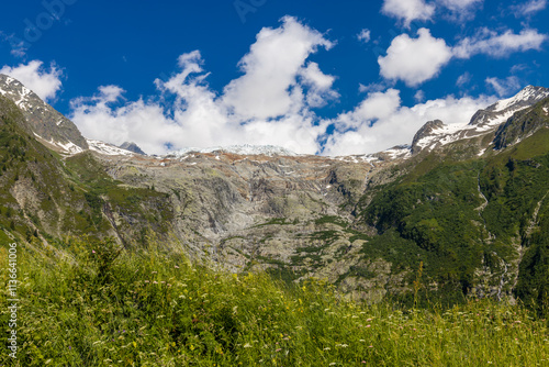 Alps scenic landscape on Tour du Montblanc. Rocky and snow summit peaks of the Alps on the trekking route TMB around Mont Blanc in Chamonix and Courmayeur. Alpine scene with mountains and lakes  photo