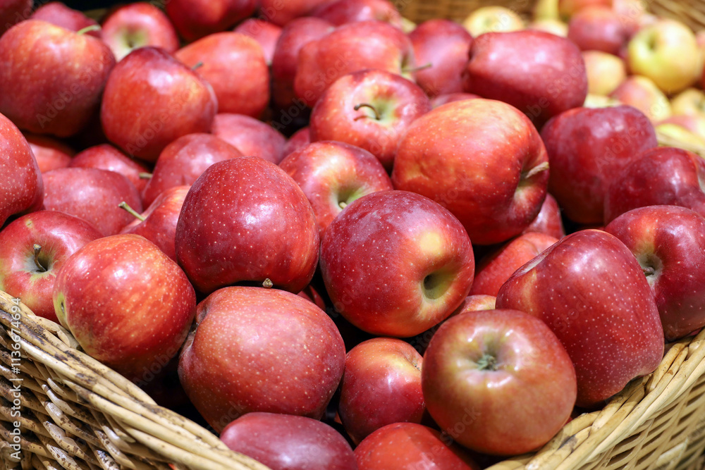 Red apples in a wicker basket. Fresh harvest, ripe fruits on in a supermarket Red apples in a wicker basket. Fresh harvest, ripe fruits on in a supermarket