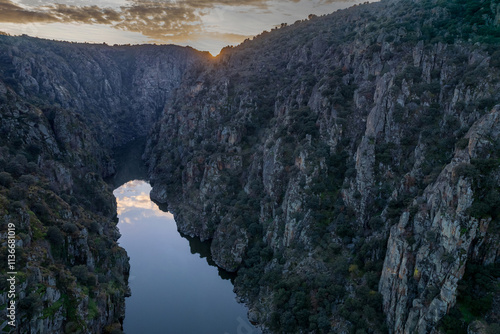 Amazing natural landscape with a panoramic view of the Douro River at sunset. From the Fraga do Puio viewpoint in Portugal we can see the water running between the cliffs with a beautiful sunlight.