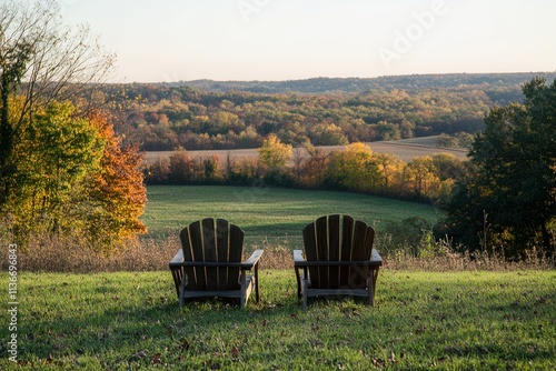 The empty wooden chairs at a winery vineyard mountains overlook the fall foliage under cloudy skies