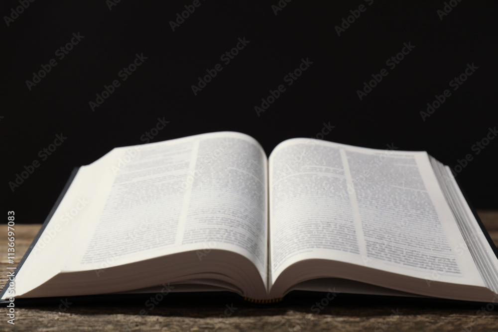 Open Holy Bible in English language on wooden table, closeup. Space for text Open Holy Bible in English language on wooden table, closeup. Space for text
