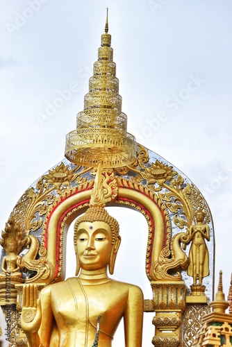 Bangkok, Thailand on 23 July 2023. Golden Buddha Statue with Intricate Thai Architecture photo