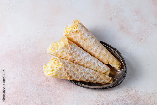 Homemade nut shaped russian soviet cookies and wafer rolls with pastry cream. photo