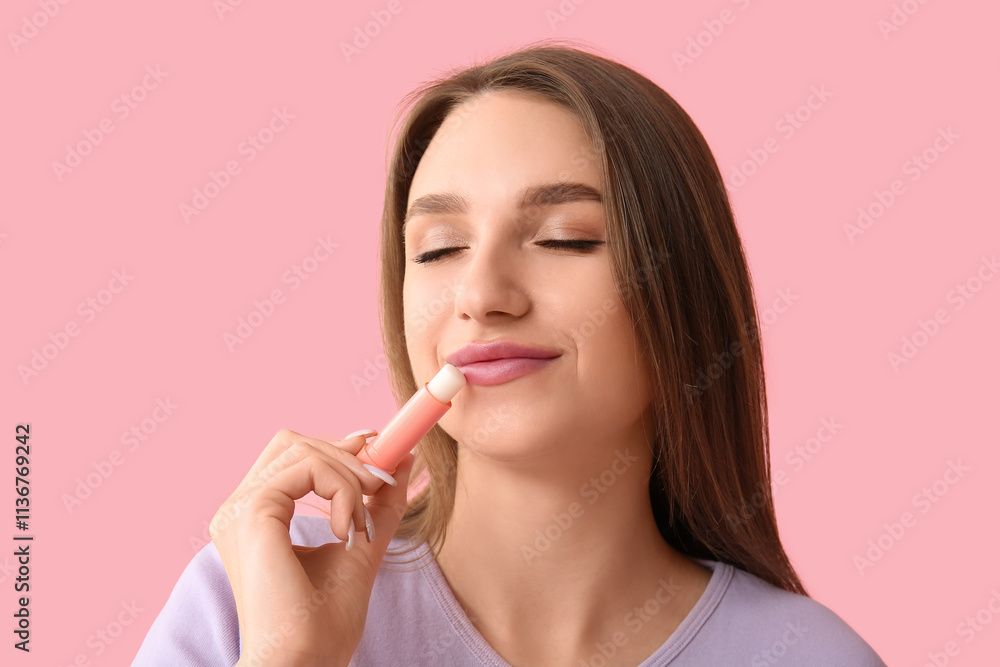 Beautiful young woman with lip balm on pink background Beautiful young woman with lip balm on pink background
