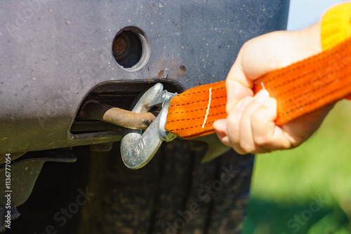 Male hand attaching towline to car photo