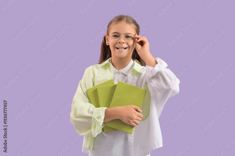 Cute schoolgirl with books on lilac background Cute schoolgirl with books on lilac background