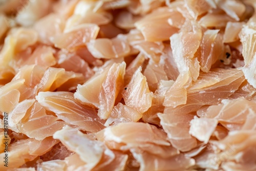 Flaky texture of tender fish fillet displayed in neat arrangement under bright light for culinary presentation photo