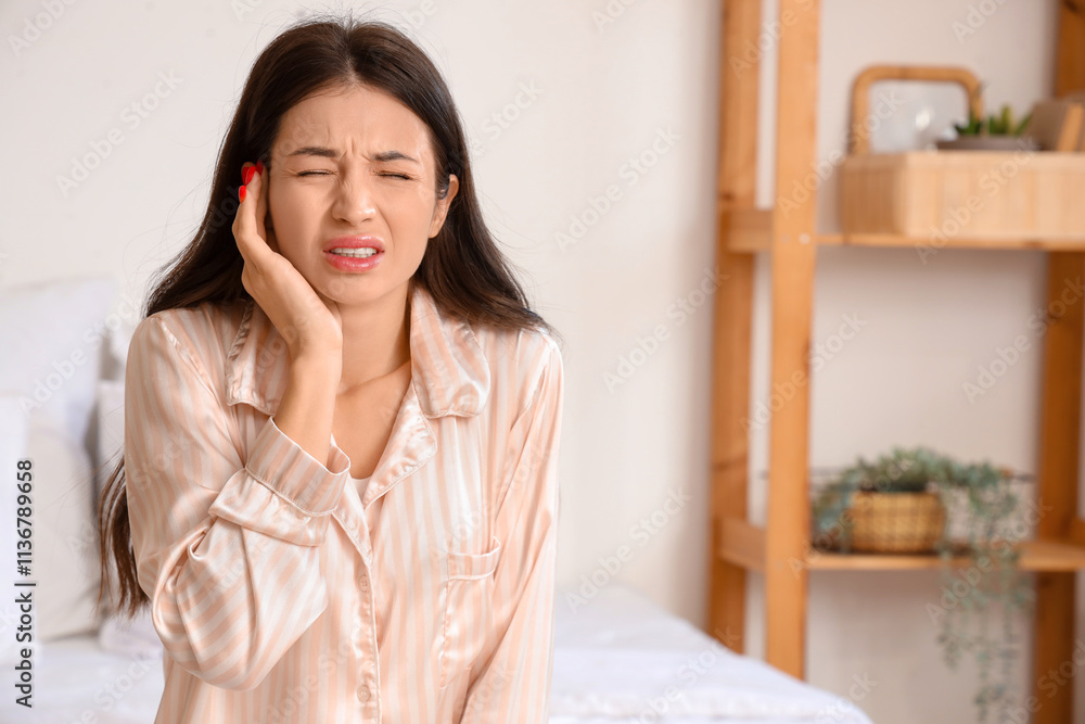 Young woman with otitis in bedroom Young woman with otitis in bedroom