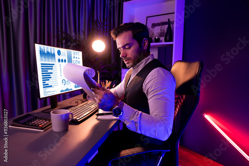 Serious smart businessman focusing on paperwork report folder analyzing sales channel discipline's product service comparing graph on pc screen market target customer at neon dark light room. Surmise.