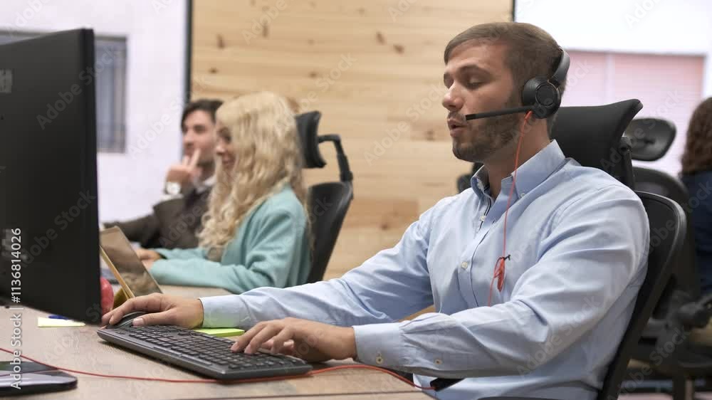 Confident businessman talking as he wears headset in coworking office Confident businessman talking as he wears headset in coworking office