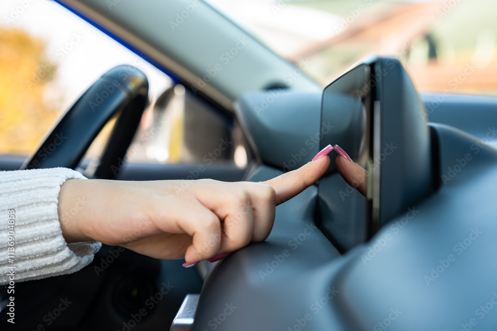 A female driver using a phone navigator in the car, A female driver using a phone navigator in the car,