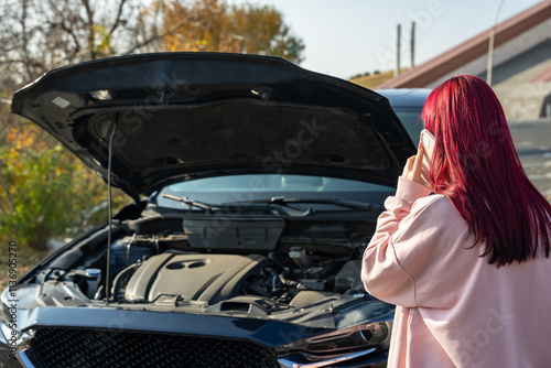 Valokuva The female driver's car broke down, the hood of the car was open, the woman call