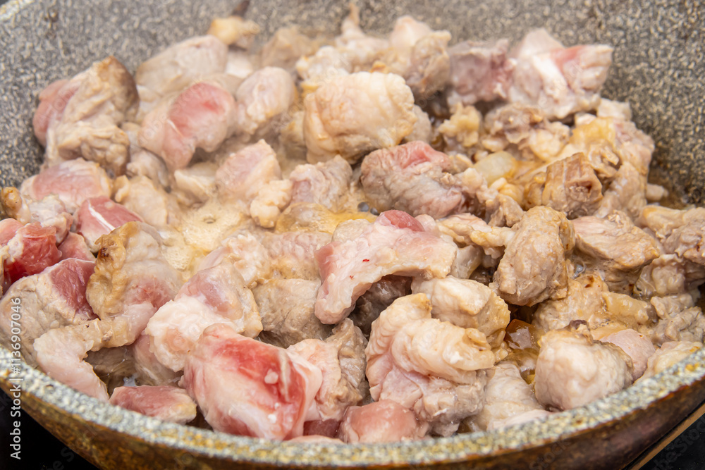 Frying pork in a frying pan. Pork goulash Frying pork in a frying pan. Pork goulash