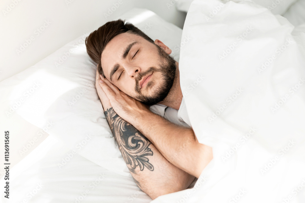 Deep male sleep. Asleep young guy sleeping resting peacefully in his comfortable bed at home. Man lying with eyes closed. Recreation, time to rest and nap concept Deep male sleep. Asleep young guy sleeping resting peacefully in his comfortable bed at home. Man lying with eyes closed. Recreation, time to rest and nap concept