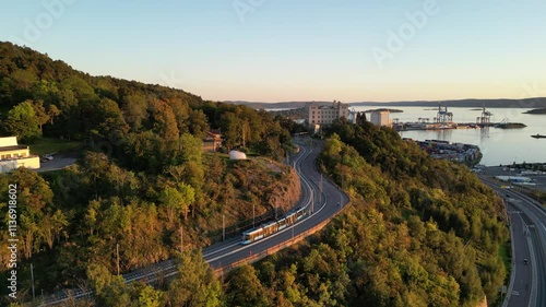 Drone over Ekebergåsen and Ekeberg in Oslo with a new tram going up the hill