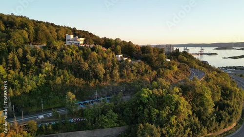 Drone over Ekebergåsen and Ekeberg in Oslo with a new tram going up the hill