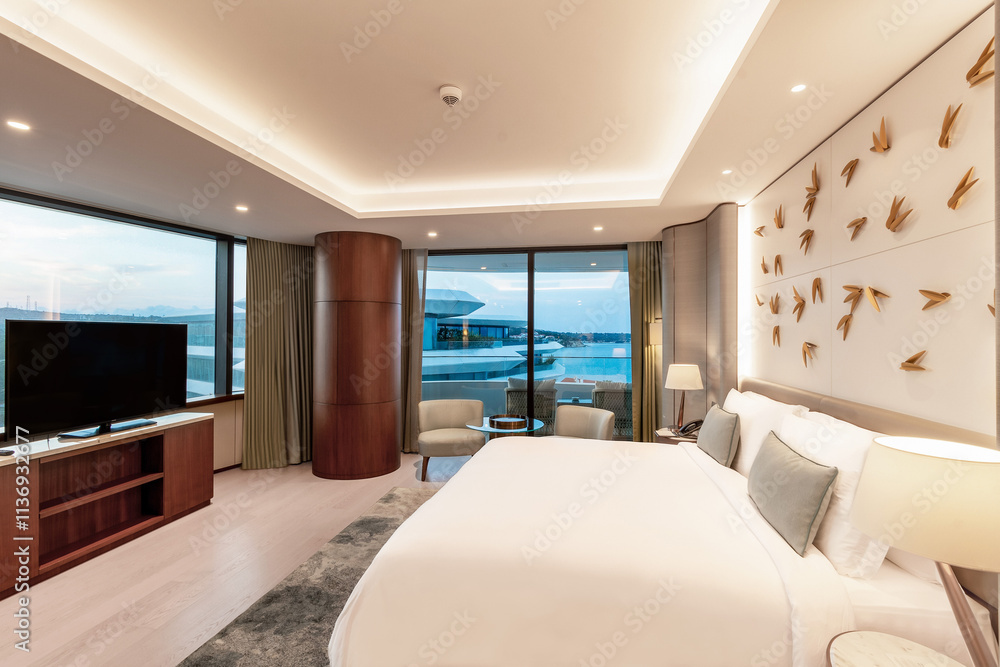 Fototapeta premium Modern hotel room with a bright and airy feel, a luxury hotel room. Example of a hotel room, modern furnishings and architecture.