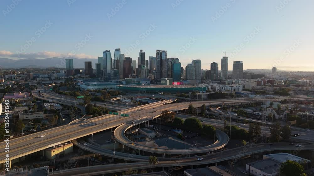 A stunning aerial view showcasing Downtown Los Angeles bathed in beautiful sunset light A stunning aerial view showcasing Downtown Los Angeles bathed in beautiful sunset light