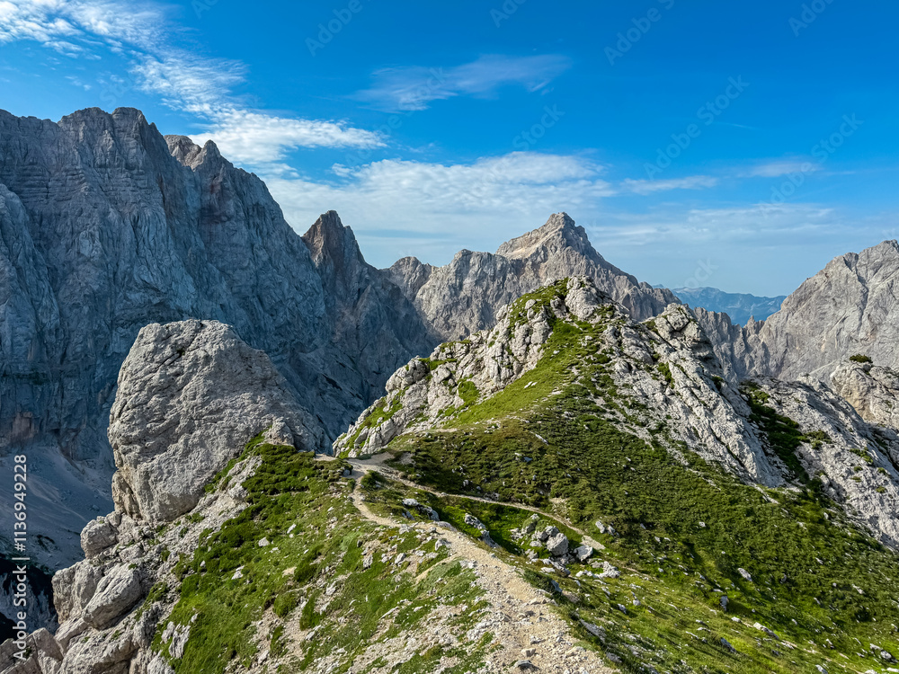 Hiking trail to Gamsova Spica with scenic view of rugged mountain peak Razor and Skrlatica, Julian Alps. Triglav National Park, Vrsic pass, Slovenia. Wanderlust Slovenian Alps. High alpine terrain Hiking trail to Gamsova Spica with scenic view of rugged mountain peak Razor and Skrlatica, Julian Alps. Triglav National Park, Vrsic pass, Slovenia. Wanderlust Slovenian Alps. High alpine terrain