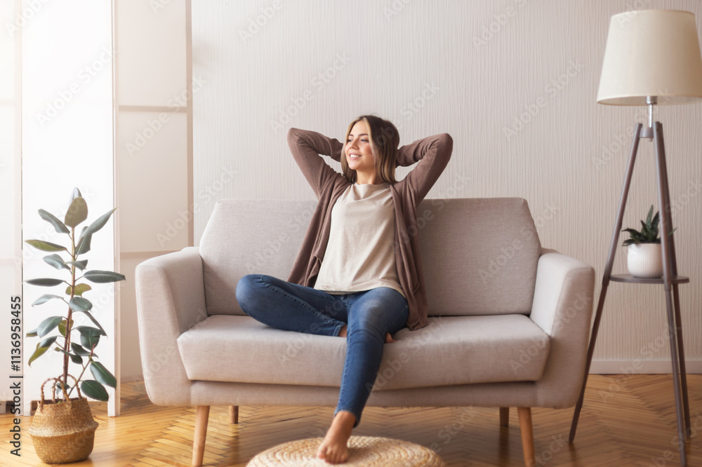 Millennial girl relaxing at home on couch, enjoying weekends, empty space Millennial girl relaxing at home on couch, enjoying weekends, empty space