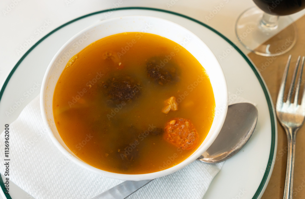 Bowl of traditional spanish dish Lentils a la Riojana - thick spicy stew with lentils, vegetables, sausages and meat Bowl of traditional spanish dish Lentils a la Riojana - thick spicy stew with lentils, vegetables, sausages and meat